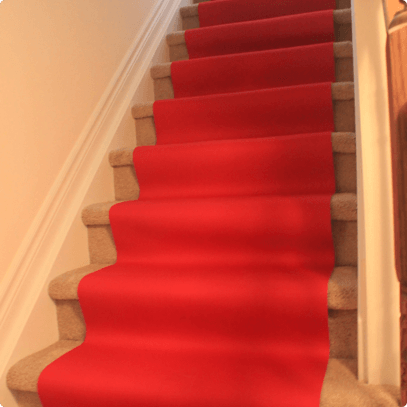 A carpet runner placed by First Rate Movers to protect stairs
